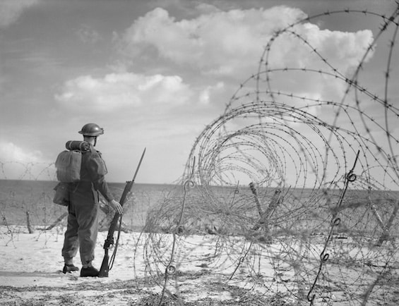 Photo of a British soldier on a beach in Southern England, 7 October 1940, part of the plan to contest a Nazi invasion of Britain.