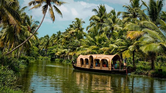 Barge on a river in Kerala, India, site of most of the action in this multi-generational saga