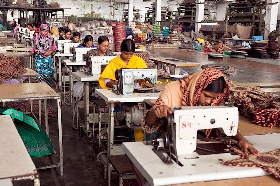 Photo of forced laborers at work in an Asian garment factory, probably 21st-century slavery