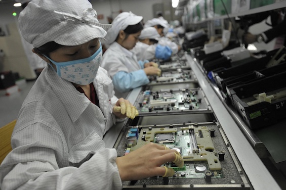 Workers at an Apple assembly plant in China, a key element in the partnership between Apple and China