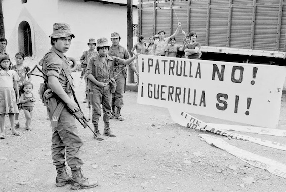 Photo of Guatemalan soldiers observing an opposition banner, background for his novel about a travel-writer-turned-MI6-agent