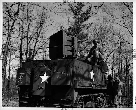 Image of a halftrack with a powerful loudspeaker mounted above it, one of the devices used by the Ghost Army