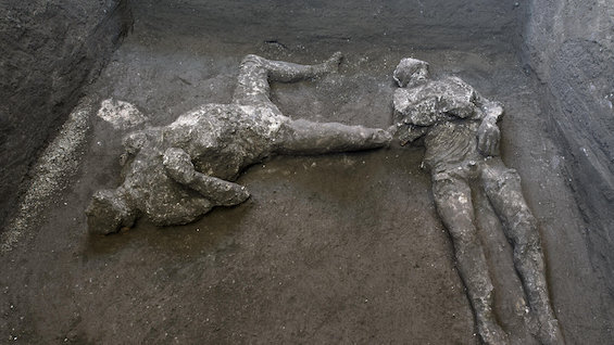 Photo of plaster casts of two victims of ancient Pompeii, the town that figures in this novel with a new twist on time travel