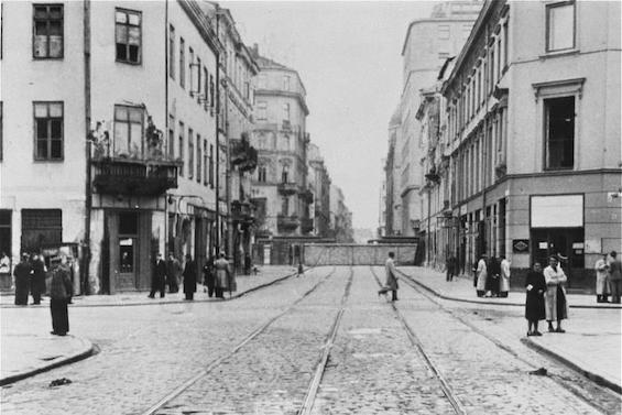 Photo of a street scene in the Warsaw Ghetto soon after its establishment in 1940, a shocking development for those living life in wartime Warsaw